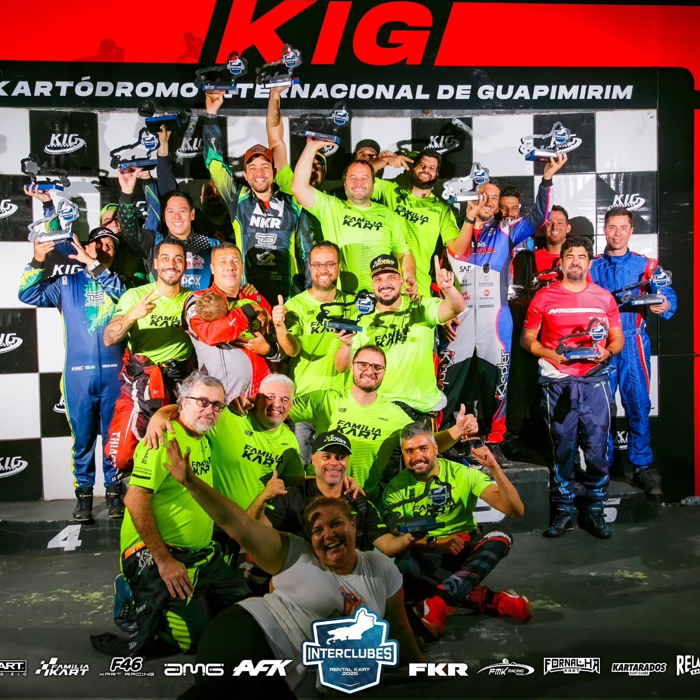 Pilotos no pódio com troféus